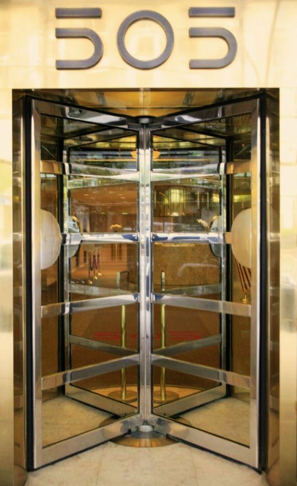 A shiny gold and silver revolving door